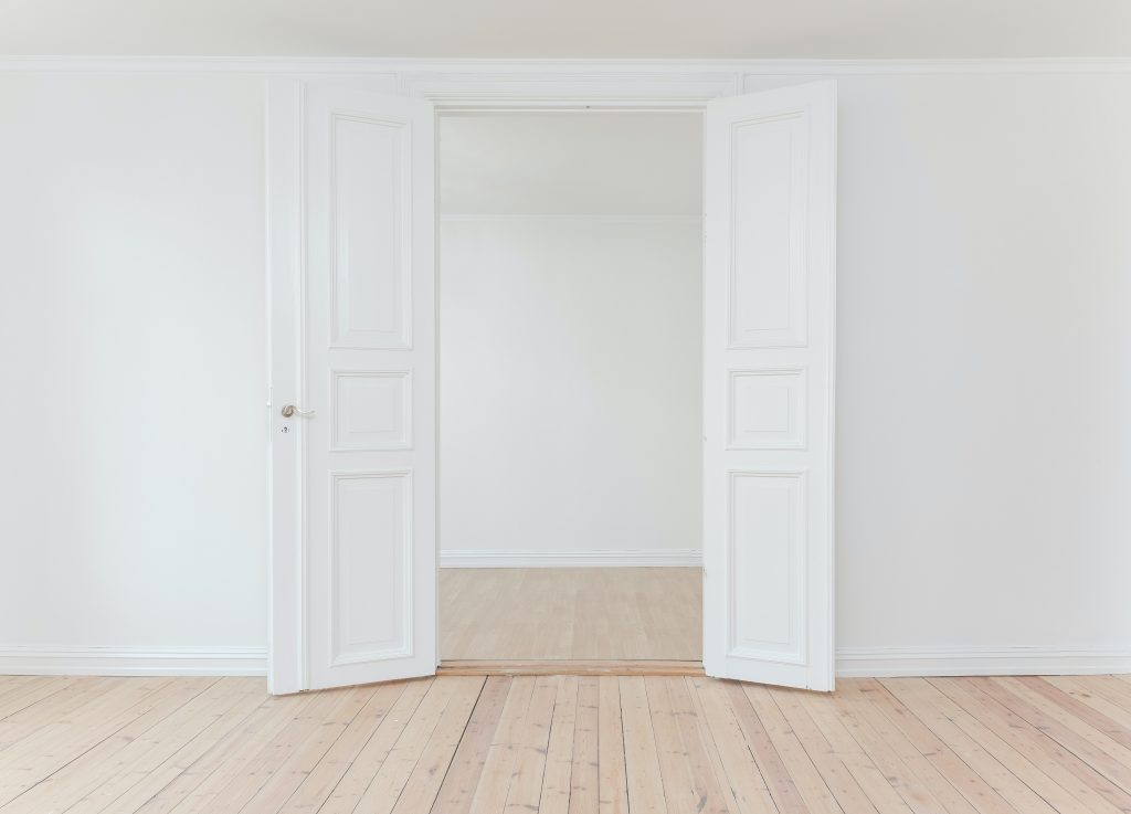 white doors, wooden floors, white walls.