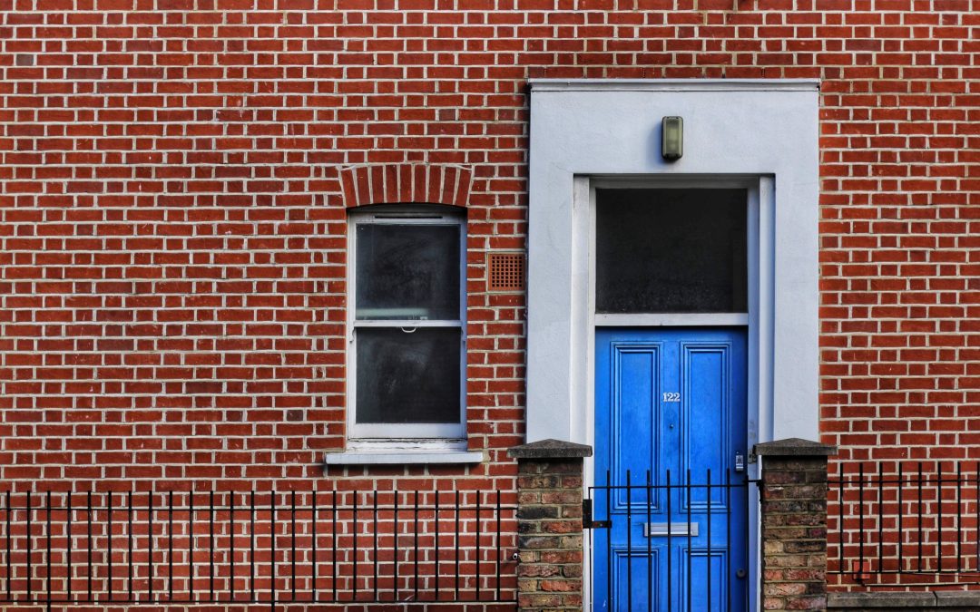 brick commercial real estate property with a blue door